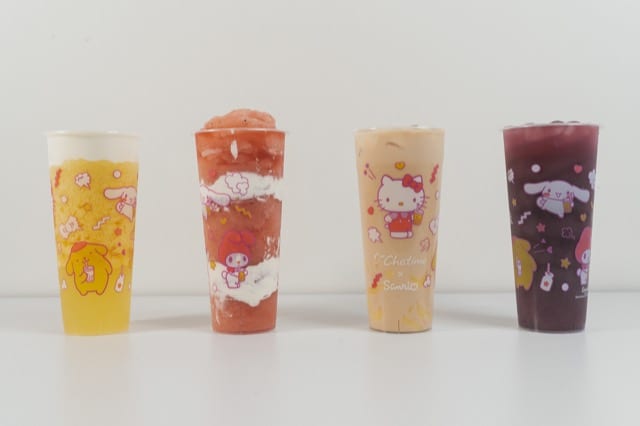 four cups of colorful bubble tea with hello kitty packaging