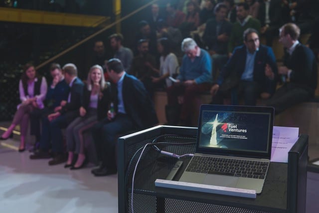 on stage view of a talk, with a laptop on a stand, it says fuel ventures
