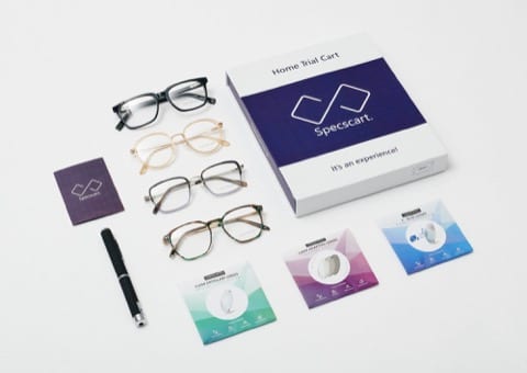 four pairs of eye glasses on a table with it's mail-to-door packaging