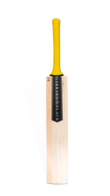 a cricket bat with light wood and yellow handle is vertical on a white background