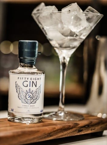 a close up photo of a small shot sized glass of gin