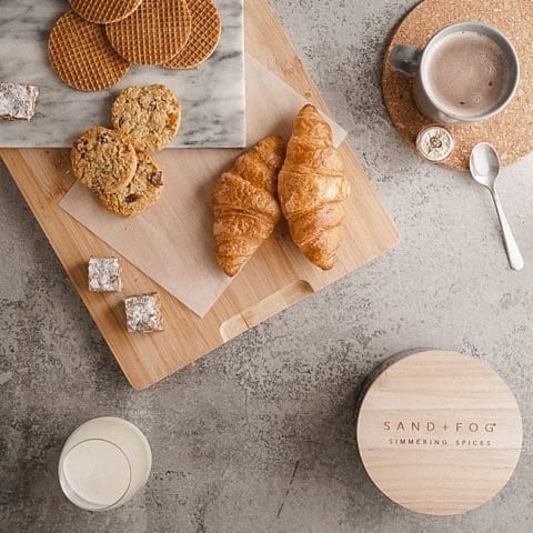 top down photo of chopping boards, coffee, crossaints