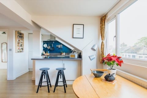 a homely flat with an open kitchen and an inviting open eating space