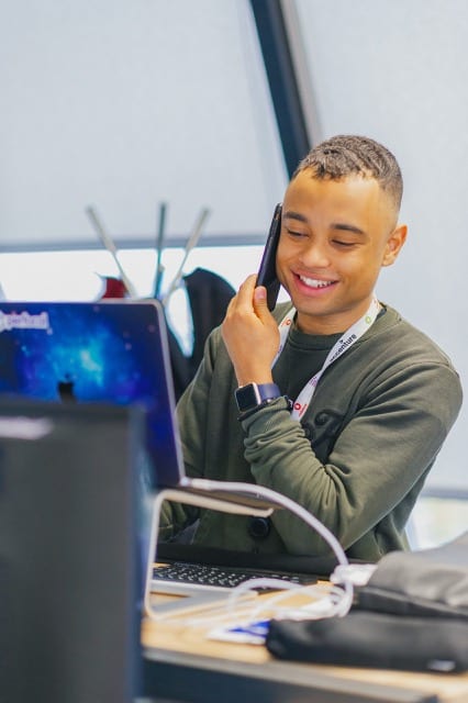 Hassan from Perfocal smiles with a phone in hand