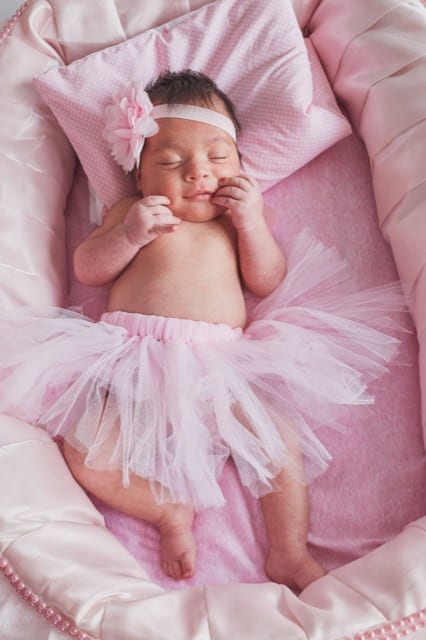 angelic photo of young baby in a pink tutu and flower headband