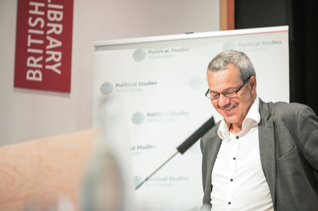 grey-haired man at a podium about to address the guests of a business event at the british library in london