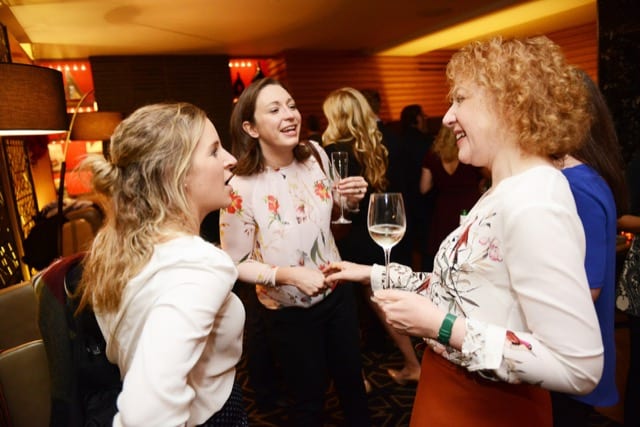 3 women networking at hakasan in London whilst holding glasses of wine
