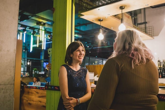 two women talking about the at an industrial start-up office
