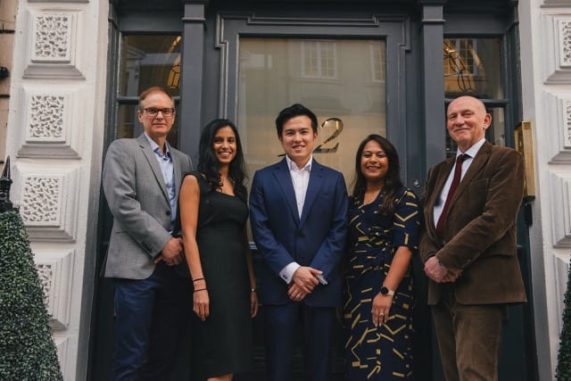 Team of 5 at Firtifa stand at the door of their new office for the team photoshoot by perfocal