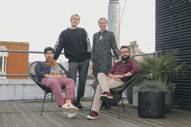 Team of 4 and a brown dachshund pose for their funding round photoshoot by perfocal