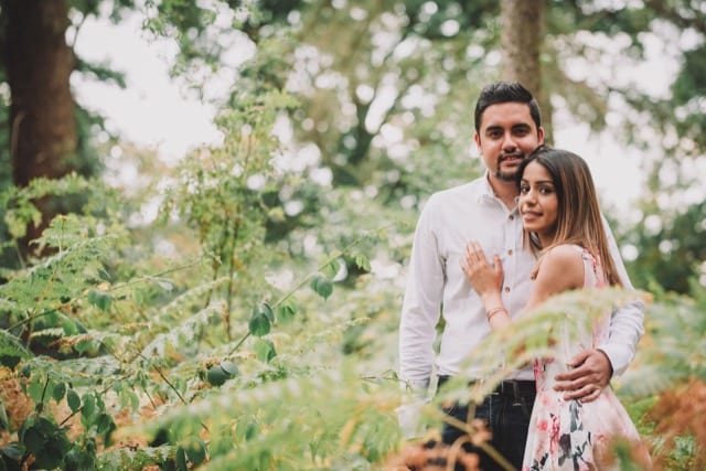 Asian couple pose for photo shoot in a park