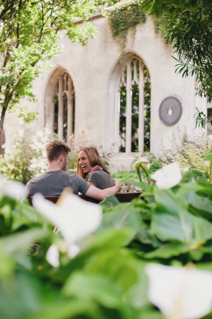 Couple sitting in a private garden, smiling at each other