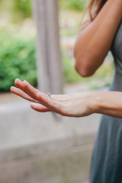 Woman stares in wonderment at her engagement ring for perfocal engagement photoshoot