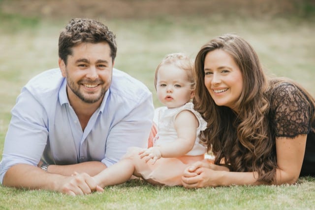 family posing with their baby girl in their garden