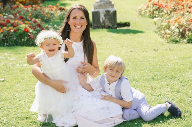 mother and children posing for photoshoot on their lawn