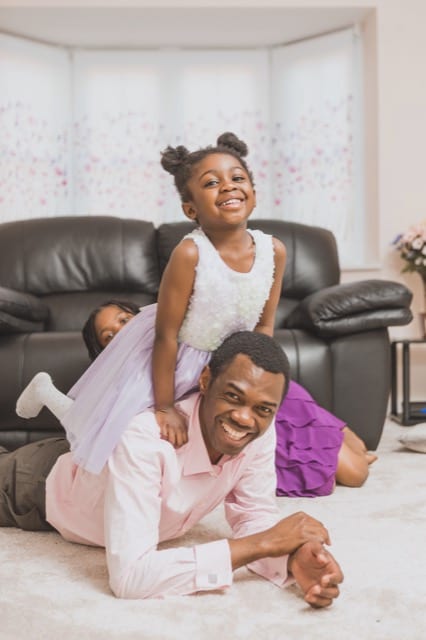 black family enjoying a Perfocal family photoshoot in their living room