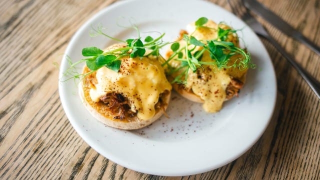 photo of a homemade english muffin topped with poached egg and fresh water cress
