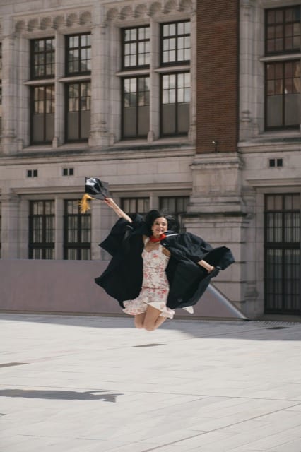 Asian girl in graduation gown celebrate with Perfocal graduation photoshoot