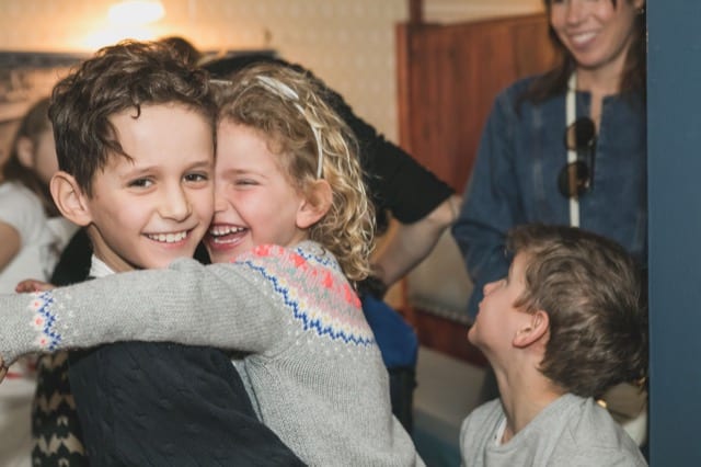 young children hugging on a birthday party