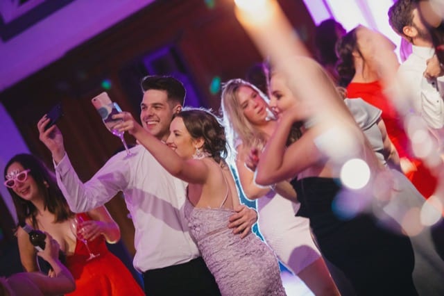 friends taking selfies on a univeristy party event