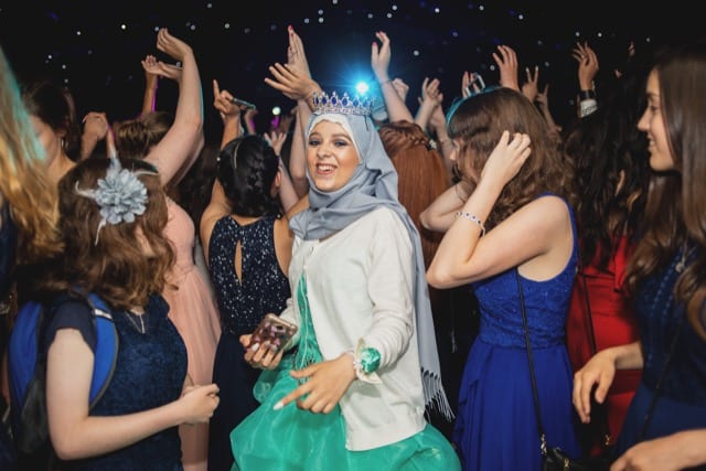muslim woman with a crown dancing in a club party