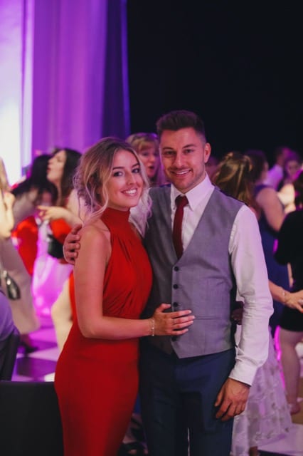 a couple pose at their ball photoshoot