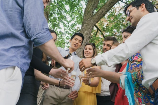 a group of friends celebrate their birthday party in hyde park with champagne