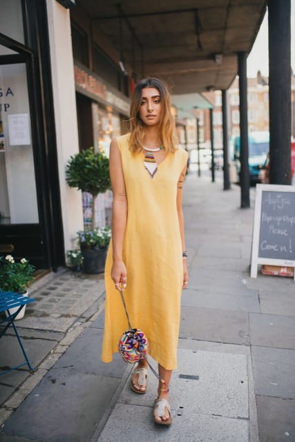 woman in yellow dress doing street fashion photography shoot