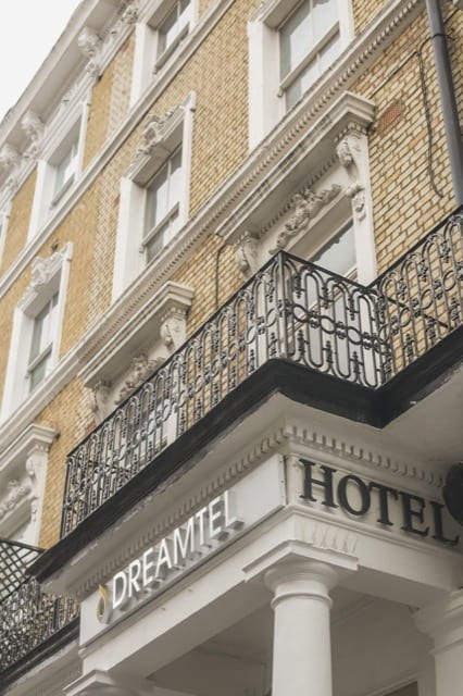 Dreamtel hotel entrance archway, with black railing balcony atop.