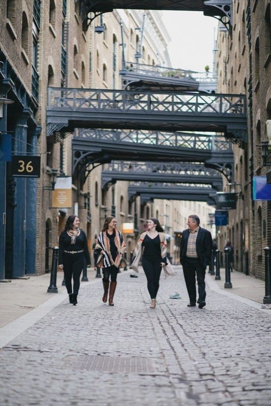 Family walk down Shad Thames street in London