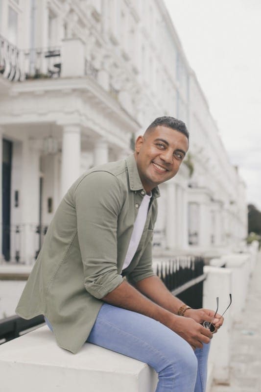 Man posing for travel photographer in Kensington, london