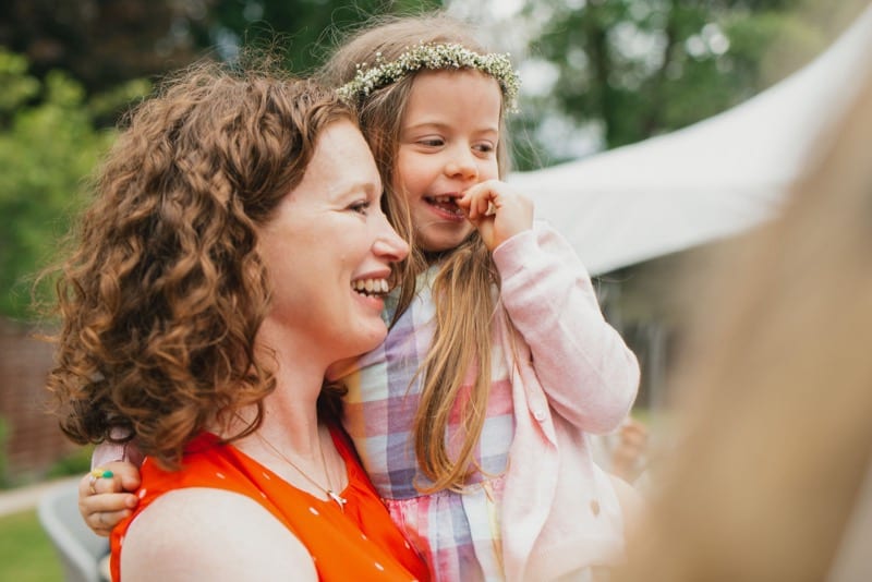 Mother holding daughter at a garden wedding photoshoot