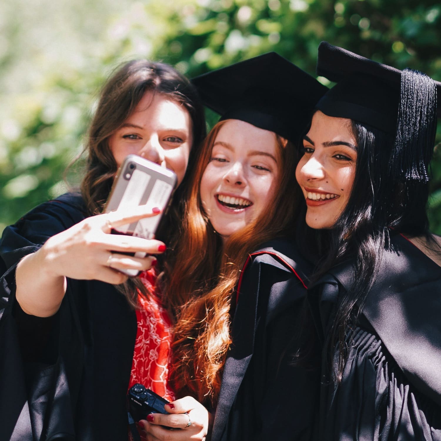 3 girls in graduation gowns