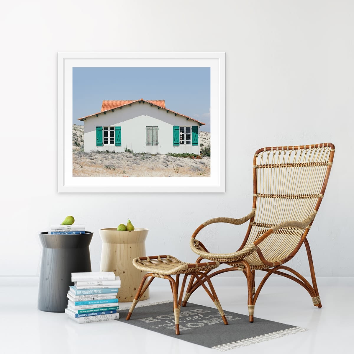 wall mounted printed frame in room with chair and books